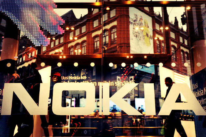 A picture taken on Oct. 21, 2010 shows the logo of Finland's mobile phone maker Nokia on the window of Nokia flagship store in Helsinki. (Markku Ulander/AFP/Getty Images;effects added by Epoch Times)