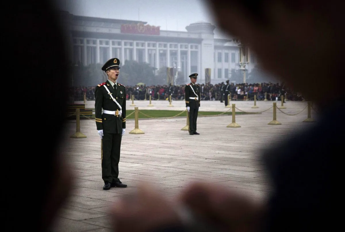 A Chinese paramilitary soldier yawns as he stands at attention while guarding in Tiananmen Square on Oct. 20, 2014 in Beijing, China. (Kevin Frayer/Getty Images)