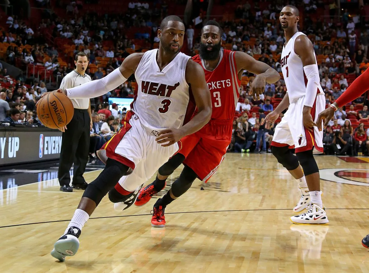 Dwyane Wade #3 of the Miami Heat drives on James Harden #13 of the Houston Rockets during a preseason game at American Airlines Arena on October 21, 2014 in Miami, Florida. (Mike Ehrmann/Getty Images)