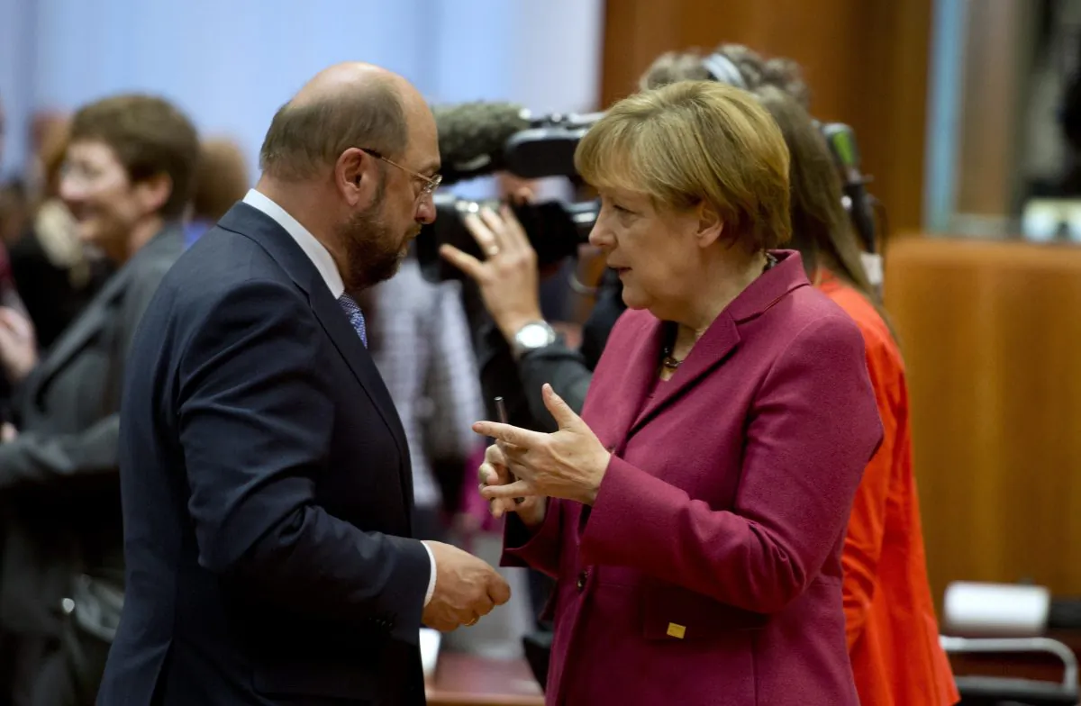 German Chancellor Angela Merkel (R) talks with European parliament president Martin Schulz before a round table as part of a European summit at the EU headquarters in Brussels on October 23, 2014. The two-day summit of the European Council in Brussels will focus on an ambitious package of climate change targets for 2030 but also tackle the Ebola crisis, economic stagnation, concern over Ukraine and tension in Cyprus over Turkey. (Alain Jocard/AFP Photo)