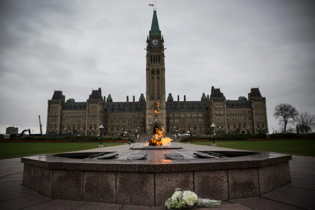 The flag atop the Canadian Parliament building is flown at half mast on Oct. 23, one day after Cpl. Nathan Cirillo of the Canadian Army Reserves was killed by a lone gunman while standing guard in front of the National War Memorial in Ottawa, Canada. After killing Cirillo the gunman stormed the main Parliament building, terrorizing the public and politicians, before he was shot dead. (Andrew Burton/Getty Images)