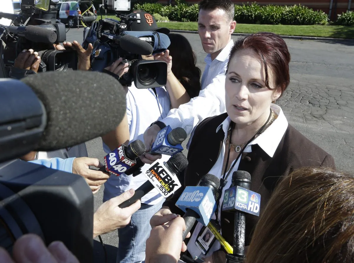Sacramento County Sheriff's spokeswoman, Sgt. Lisa Bowman, talks to reporters about the shooting of Sacramento Sheriff's deputy by an assailant who then carjacked two vehicles prompting a manhunt in Sacramento, Calif., Friday, Oct. 24, 2014.  The suspect is believed to be the same person who later shot two Placer County Sheriff's deputies. Authorities are searching a canyon in the Sierra Nevada foothills near Auburn for the suspected in the shooting of the three law enforcement officers and a bystander in an attempt to carjack a vehicle.(AP Photo/Rich Pedroncelli)
