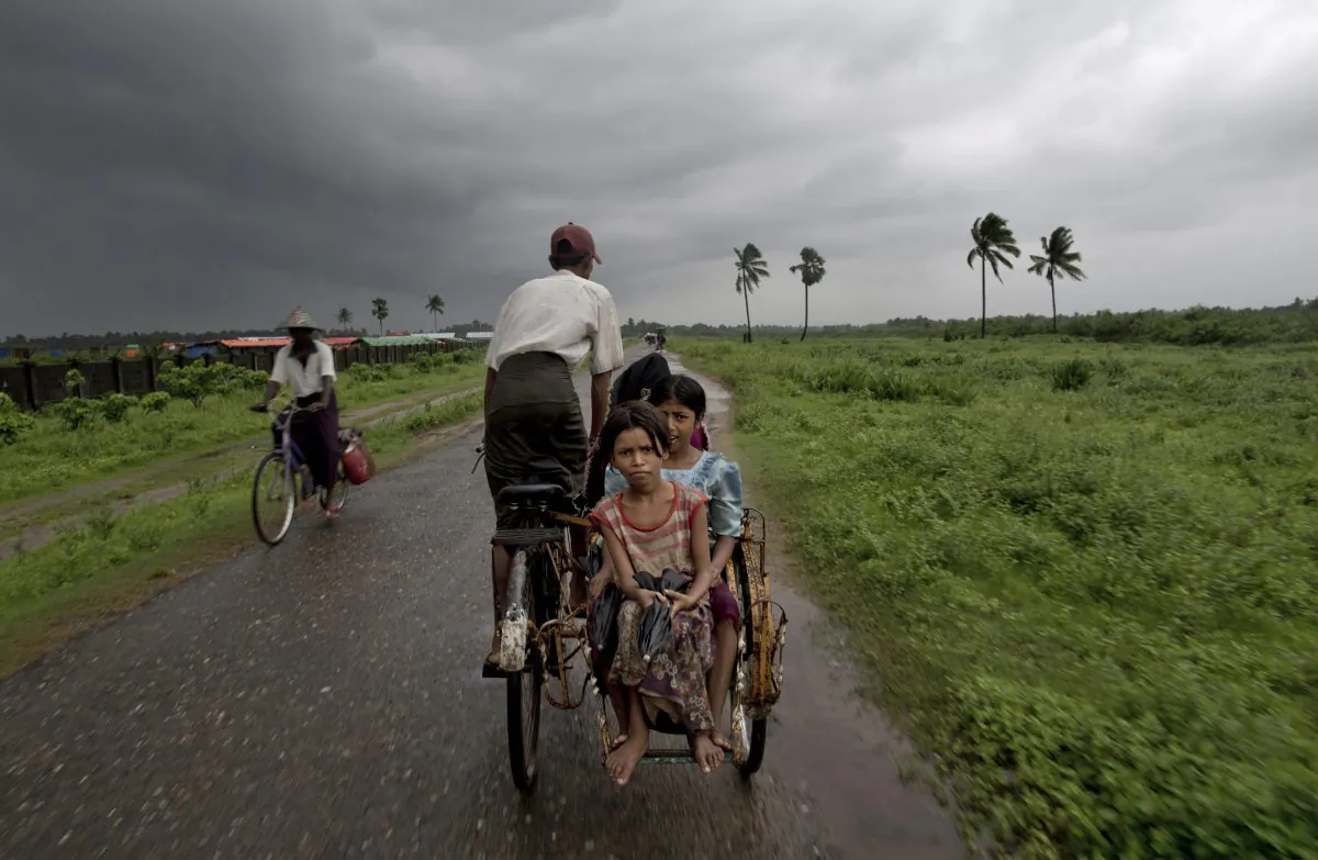  Rohingya children travel in a rickshaw in north of Sittwe, Rakhine State, Myanmar. A growing sense of desperation is fueling a mass exodus of Rohingya Muslims from western Myanmar, with at least 8,000 members of the long-persecuted minority fleeing by boat in the last two weeks, according to an expert. (AP Photo/Gemunu Amarasinghe)