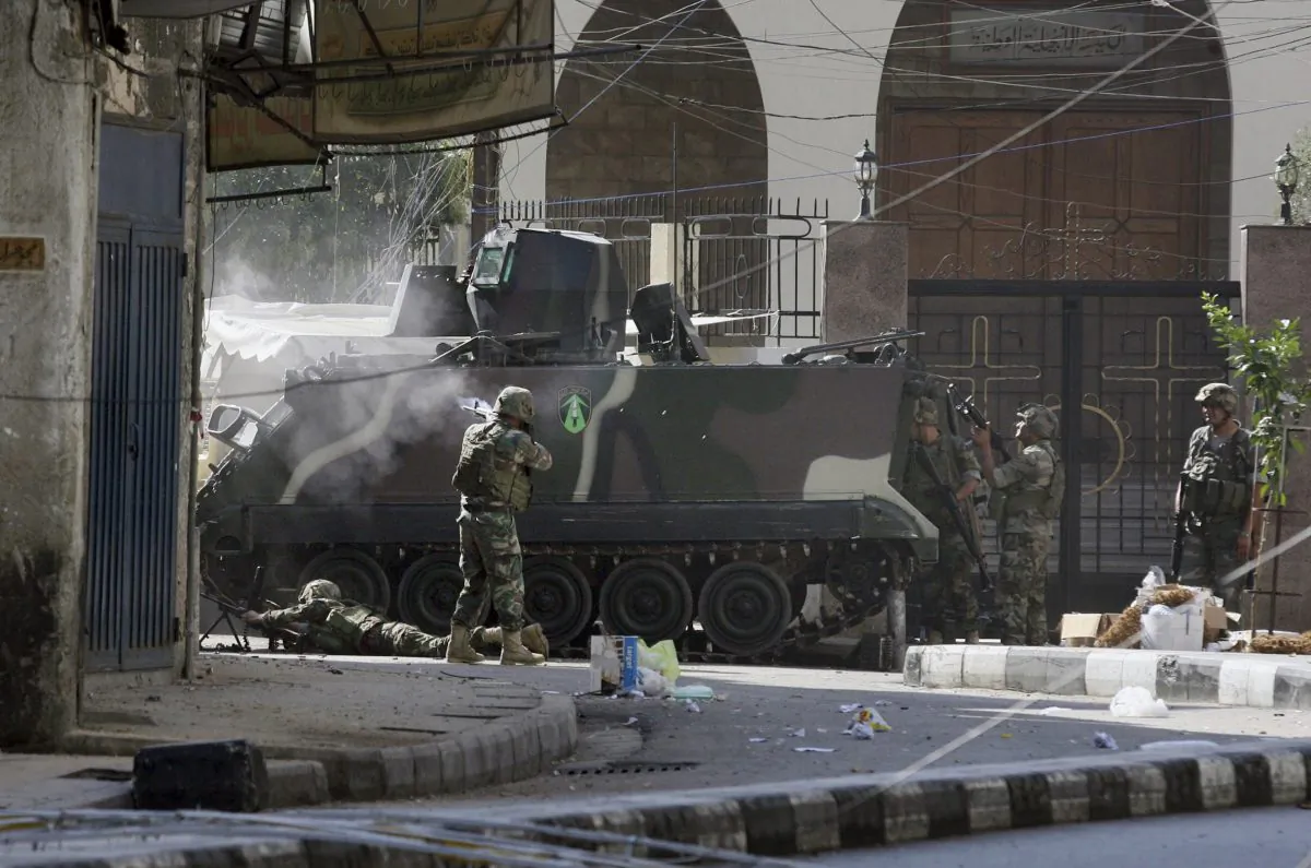 Lebanese army soldiers open fire during clashes with Islamic militants in the northern port city of Tripoli, Lebanon, Saturday, Oct. 25, 2014. Lebanese troops battled Islamic militants in Tripoli for a second day Saturday, with at least one person killed and a dozen people wounded in the clashes, the Lebanese army and state media said. (AP Photo)