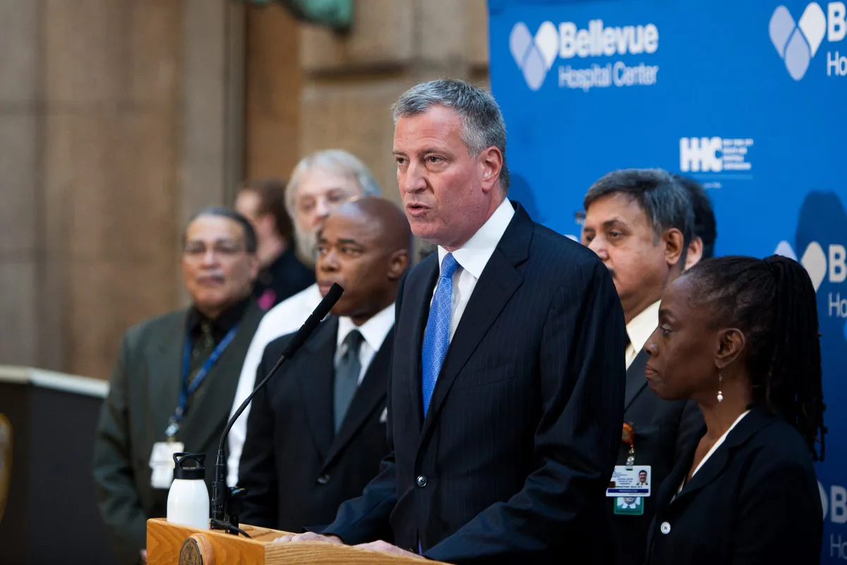 New York City Mayor Bill de Blasio, with his wife Chirlane McCray, provides an update on the Ebola situation in the city at a press conference at Bellevue Hospital in Manhattan, New York City, on Oct. 26, 2014. (Petr Svab/Epoch Times)