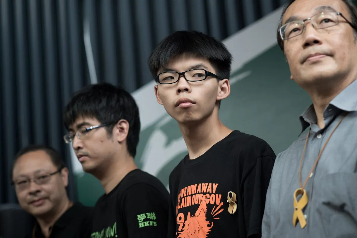 (L-R) Benny Tai of prominent pro-democracy group Occupy Central and Hong Kong student leaders Alex Chow, Joshua Wong, and Alan Leong, of the Civic Party attend a press conference at the pro-democracy protesters camp site in the Admiralty district of Hong Kong on Oct. 26, 2014. (Nicolas Asfouri/AFP/Getty Images)