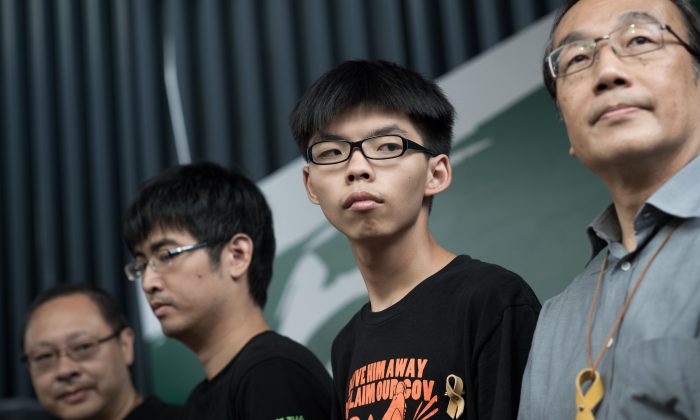 (L-R) Benny Tai of prominent pro-democracy group Occupy Central and Hong Kong student leaders Alex Chow, Joshua Wong, and Alan Leong, of the Civic Party attend a press conference at the pro-democracy protesters camp site in the Admiralty district of Hong Kong on Oct. 26, 2014. (Nicolas Asfouri/AFP/Getty Images)