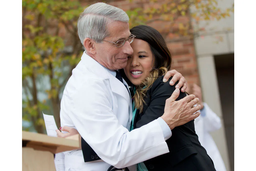 Patient Nina Pham is hugged by Dr. Anthony Fauci, director of the National Institute of Allergy and Infectious Diseases, outside of National Institutes of Health (NIH) in Bethesda, Md., Friday, Oct. 24, 2014. Pham, the first nurse diagnosed with Ebola after treating an infected man at a Dallas hospital is free of the virus. The 26-year-old Pham arrived last week at the NIH Clinical Center. She had been flown there from Texas Health Presbyterian Hospital Dallas. (AP Photo/Pablo Martinez Monsivais)