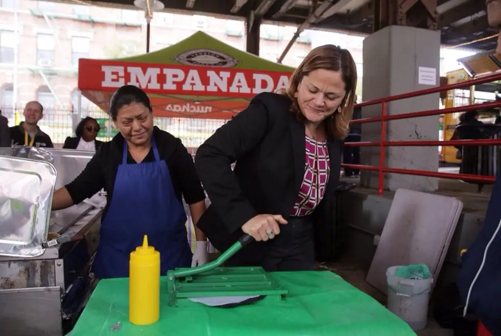 Local food vendor Marta Gonzalez (L) teaches Speaker Melissa Mark-Viverito to make a gordita at La Marqueta in East Harlem, N.Y., Oct. 26, 2014. (Will Alatriste)