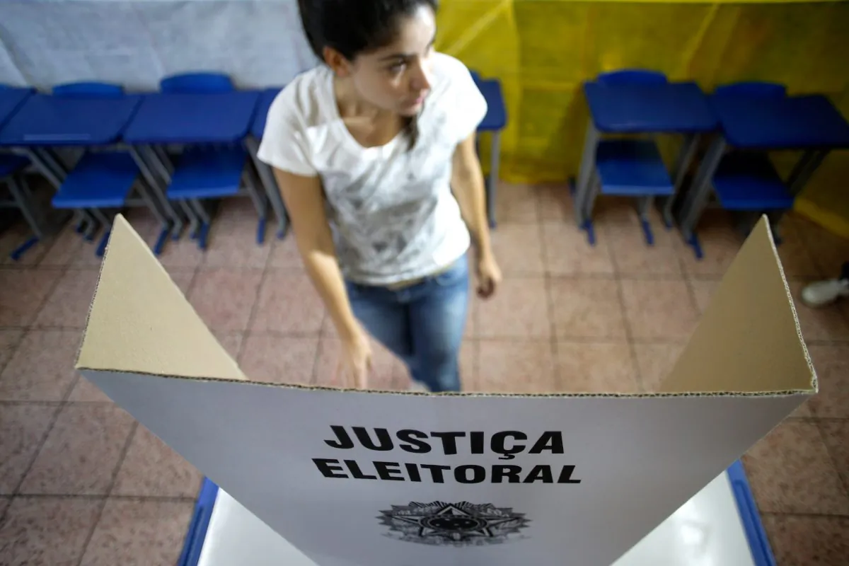 An electoral worker assembles a voting station at a school in Brasilia, Brazil, Saturday, Oct. 25, 2014. Brazilians will go to the polls on Sunday to decide who'll be the next leader of Latin America's biggest economy. (AP Photo/Eraldo Peres)
