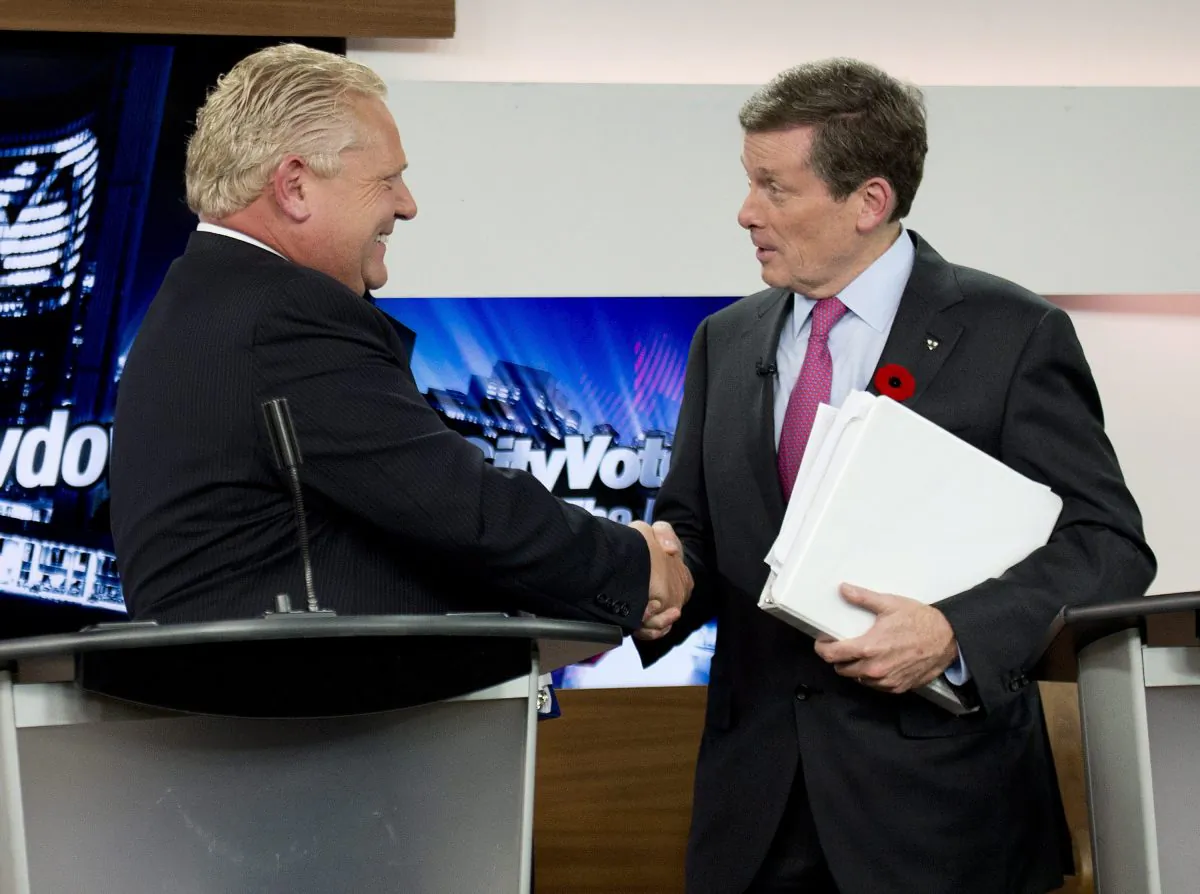 Toronto mayoral candidates Doug Ford (L) and John Tory shake hands during the final mayoral debate for the Toronto mayoral race in Toronto on Oct. 23, 2014. Voters head to the polls Monday, Oct. 27, 2014, to elect a successor to Rob Ford, who announced last month that he would not seek re-election as he battles a rare and difficult form of cancer. Doug Ford is running in his place but is widely expected to lose to Tory. (AP Photo/The Canadian Press, Nathan Denette)