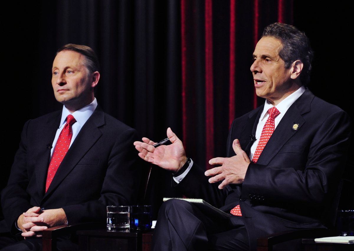 New York State Gubernatorial Candidate Republican candidate Rob Astorino (L) listens to the response of Democratic incumbent Andrew Cuomo, about fracking during a debate in Buffalo, N.Y., Wednesday, Oct. 22, 2014. (AP Photo/Gary Wiepert)