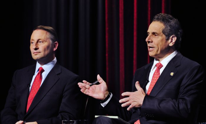New York State Gubernatorial Candidate Republican candidate Rob Astorino (L) listens to the response of Democratic incumbent Andrew Cuomo, about fracking during a debate in Buffalo, N.Y., Wednesday, Oct. 22, 2014. (AP Photo/Gary Wiepert)