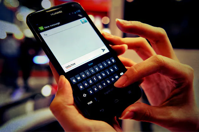 This photo, taken on June 21, 2012, shows a person using a mobile phone touch screen keypad to write a text message in Singapore. (Roslin Rahman/AFP/GettyImages; effects added by Epoch Times)