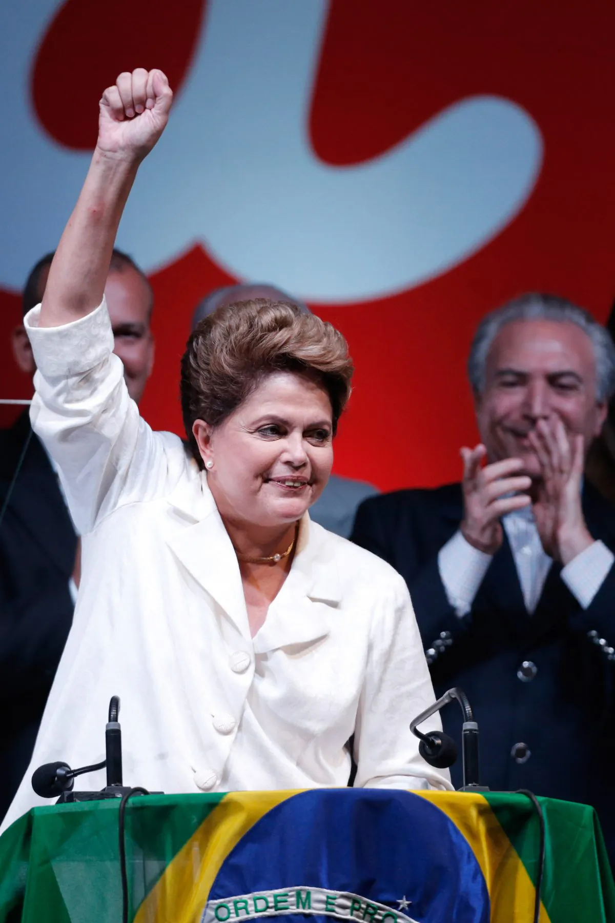 Brazil's President Dilma Rousseff celebrates her victory at a hotel in Brasilia, Brazil, Sunday, Oct. 26, 2014. Official results showed Sunday that President Rousseff defeated opposition candidate Aecio Neves of the Brazilian Social Democracy Party, and was re-elected Brazil's president. (AP Photo/Eraldo Peres)
