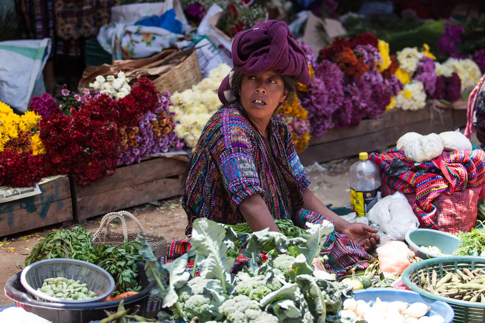 Woman sells vegetables and flowers at traditional weekly market in Chichicastenango (Shutterstock*)