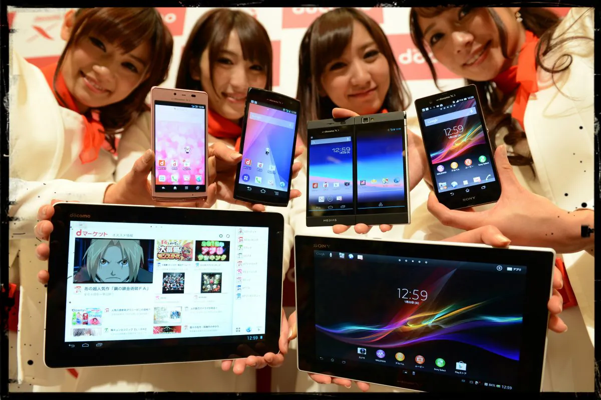 Models show off NTT Docomo's new smartphones (top from L; Aquos Phone EX, Arrows X, Medias W and Xperia Z) and tablets (lower from L; Xperia Tablet Z and 'dtab') during the company's 2013 Spring lineup press preview in Tokyo on January 22, 2013. (Toshifumi Kitamura/AFP/Getty Images; effects added by Epoch Times)