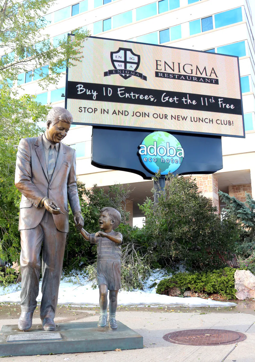 A bronze statue of John F. Kennedy and his son grace the entrance to the Adoba Hotel. Fine dining at their Enigma Restaurant awaits. (Myriam Moran copyright 2014)