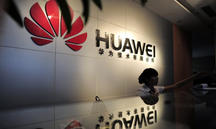 A receptionist at the office of Chinese telecommunications firm Huawei in Wuhan City, China on Oct. 8, 2012. (STR/AFP/Getty Images)