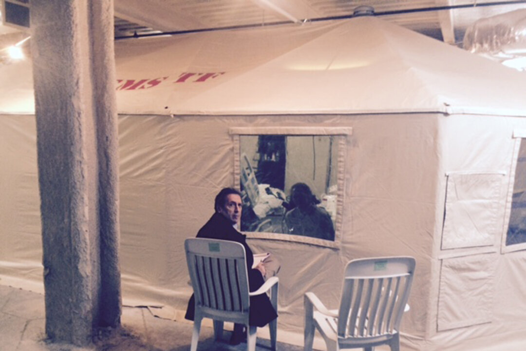 In this Oct. 26, 2014, photo, provided by attorney Steven Hyman, quarantined nurse Kaci Hickox meets with the prominent New York civil rights attorney Norman Siegel, seated, at the isolation tent at University Hospital in Newark, N.J., where Hickox was confined after flying into Newark Liberty International Airport following her work in West Africa caring for Ebola patients. For Americans wondering why President Barack Obama hasn’t forced all states to follow a single, national rule for isolating potential Ebola patients, the White House has a quick retort: Talk to the Founding Fathers. A hodgepodge of state policies, some of which directly contradict Obama’s recommendations, has sowed confusion about what’s really needed to stop Ebola from spreading in the United States. While public health advocates denounce state quarantines as draconian and scientifically baseless, anxious citizens in non-quarantine states are asking whether they’re at greater risk because their governors and the president have adopted a lesser level of caution. (AP Photo/Steven Hyman)