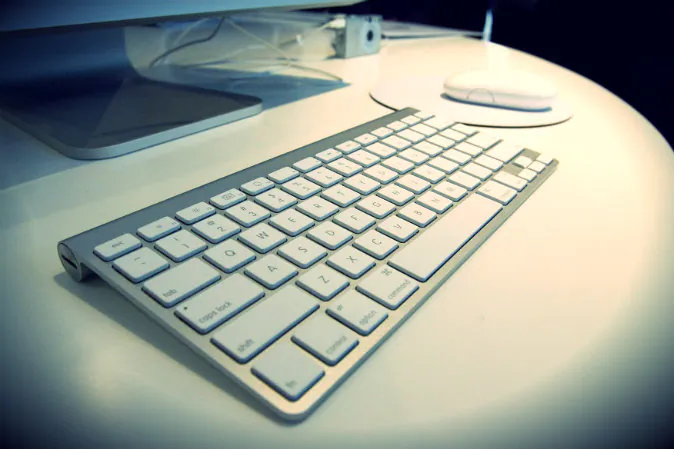 The new wireless keyboard is displayed after Apple CEO Steve Jobs introduced new versions of the iMac and iLife applications in Cupertino, Calif on Aug. 7, 2007. (David Paul Morris/Getty Images; effects added by Epoch Times)