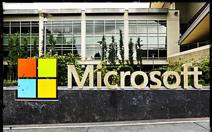 This photo taken July 3, 2014 shows the Microsoft Corp. logo outside the Microsoft Visitor Center in Redmond, Wash. (Ted S. Warren/AP Photo; effects added by Epoch times)