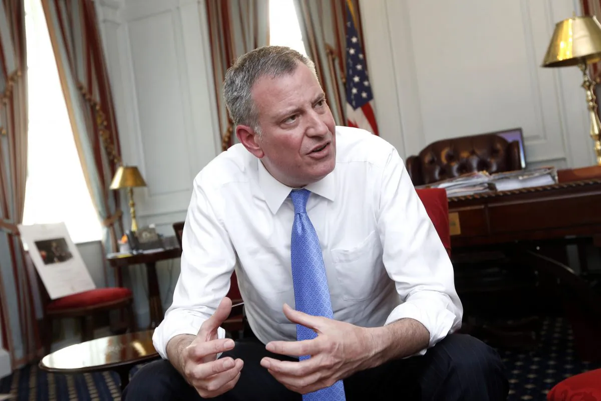 New York Mayor Bill de Blasio gives an interview at City Hall, New York, Wednesday, April 9, 2014. In an interview with The Associated Press Monday Oct. 27, 2014, de Blasio talked about his love of baseball, his three years coaching his son’s Little League team, and how he often draws upon that experience in managing a city of 8 million people. (AP Photo/Jason DeCrow)