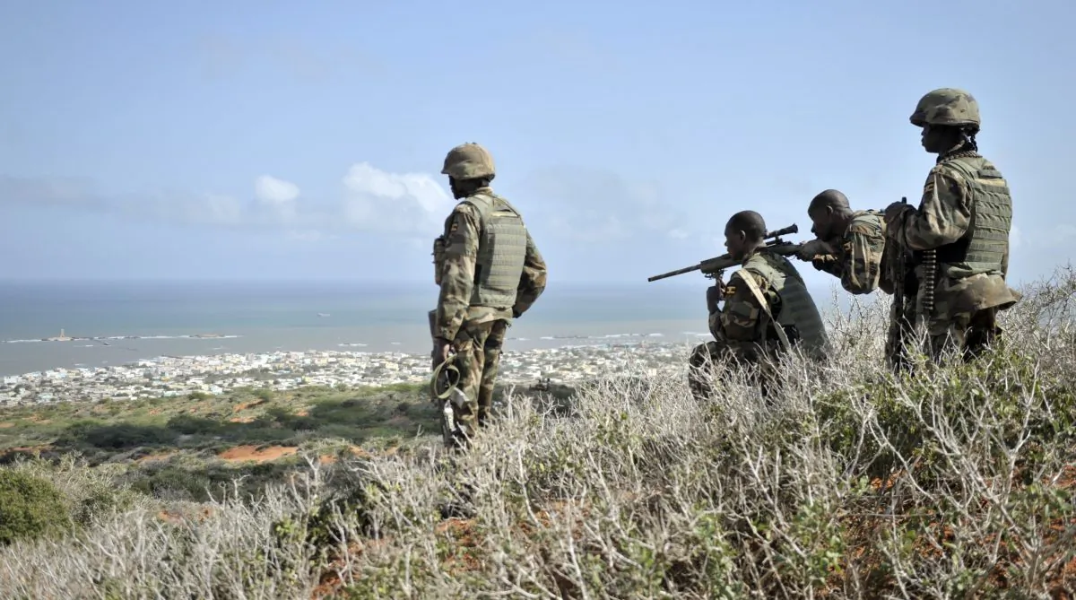 African Union (AU) soldiers look for enemy combatants through the scope of a rifle on a hill overlooking the al-Shabab stronghold of Barawe, a coastal town 135 miles southwest of Mogadishu, in Somalia, on Oct. 5, 2014. (Tobin Jones/AMISOM via AP)