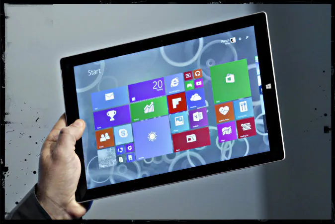 Panos Panay, Microsoft's vice president for surface computing, introduces the Surface Pro 3 tablet device at a media preview in New York on May 20, 2014.(Mark Lennihan/AP Photo; effects added by Epoch Times)
