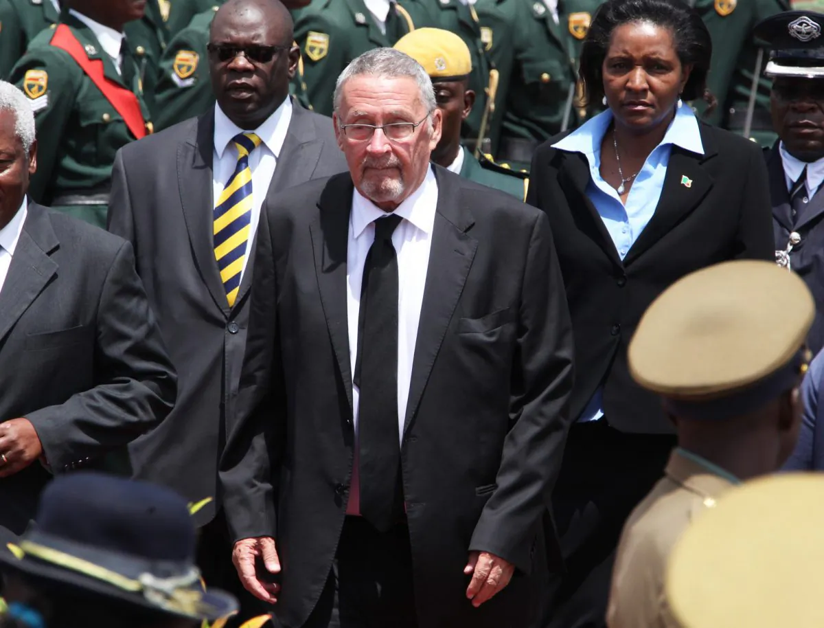 Zambian deputy president Guy Scott (C) attends the burial of Zimbabwe's deputy president John Nkomo, at the Heroes Acre, in Harare, Zimbabwe, on Jan 21, 2014. Following the death of Zambian President Michael Sata, the Zambian government says Guy Scott will become acting president of the southern African nation until new elections are held within 90 days. President Michael Sata, who had been gravely ill in a London hospital, died late Tuesday. (AP Photo/Tsvangirayi Mukwazhi)