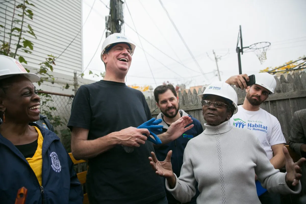 New York City mayor Bill de Blasio (C), with his wife Chirlane McCray (L) and owner of a Superstorm-Sandy-damaged home, Margurie Batts (R), at Batts's home in Coney Island, Wednesday, Oct. 29, 2014. On Wednesday, the city announced a collaboration with local nonprofits and community organizations that would link homeowners to repair services. (William Alatriste/New York City Council)