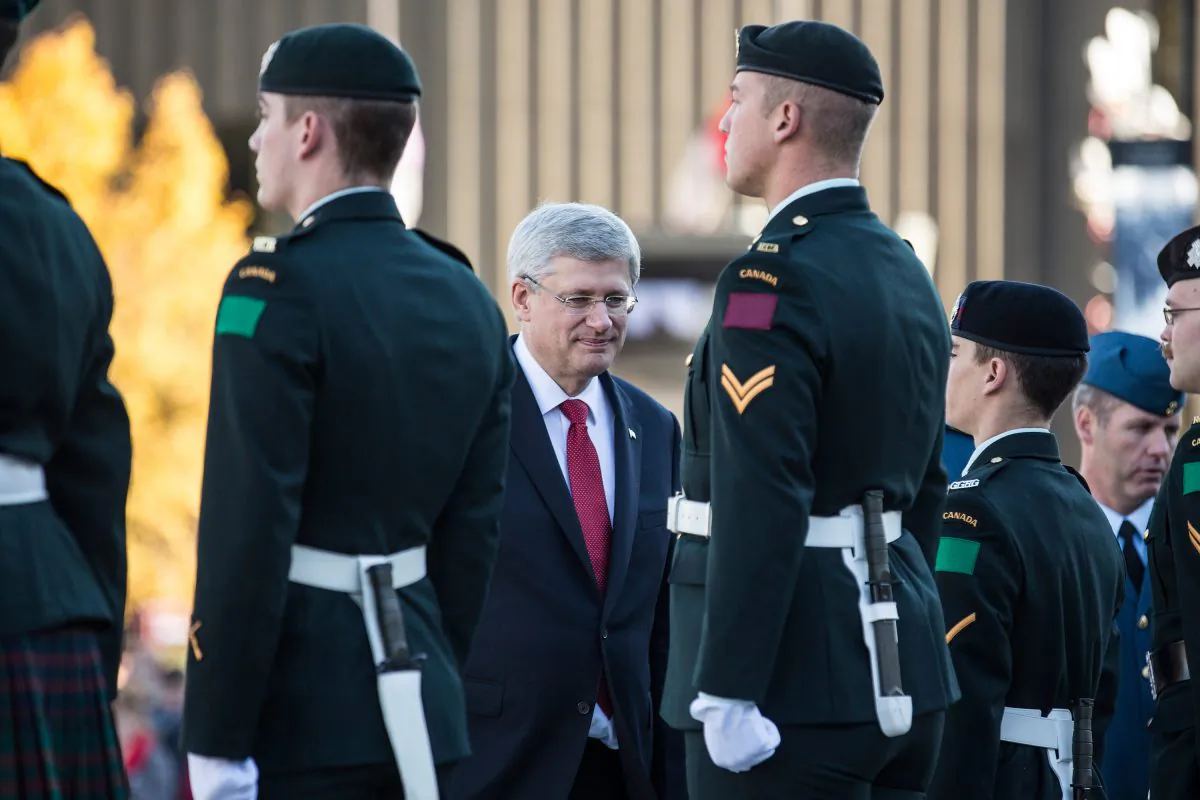 Canadian Prime Minister Stephen Harper meets with soldiers in the Canadian army during a ceremony at the National War Memorial on Oct. 24, 2014 in Ottawa, Canada. It was here two days earlier that a gunman killed Cpl. Nathan Cirillo, a soldier guarding the memorial. (Andrew Burton/Getty Images)