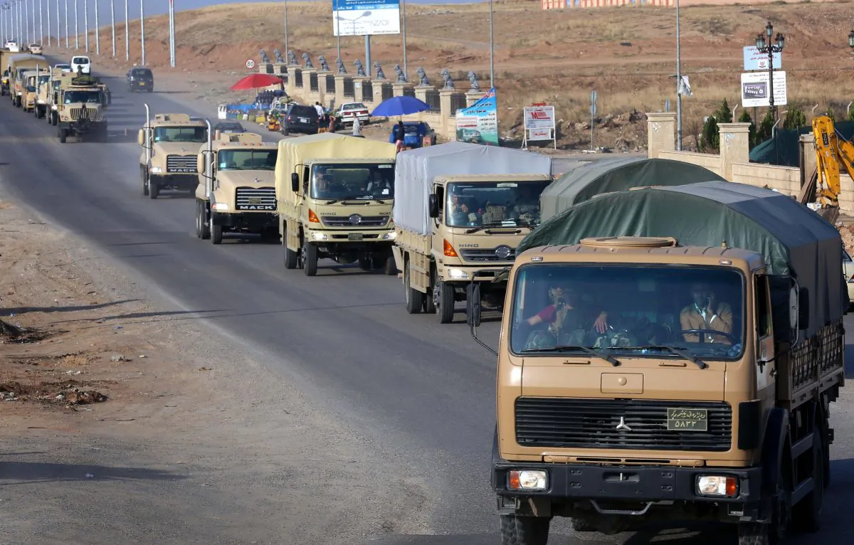 Dozens of Kurdish peshmerga fighters drive through Arbil after leaving a base in northern Iraq on Oct. 28, 2014, on their way to the battleground Syrian town of Kobani. 'Forty vehicles carrying machineguns and weapons and artillery with 80 of the peshmerga forces will head to Dohuk (province) and then cross the border today,' a Kurdish officer told AFP. A further 72 will fly to Turkey the following day, the officer said. The town on the Turkish border has become a crucial front in the fight against the Islamic State (IS) group, which overran large parts of Iraq in June and also holds significant territory in Syria. (Safin Hamed/AFP/Getty Images)