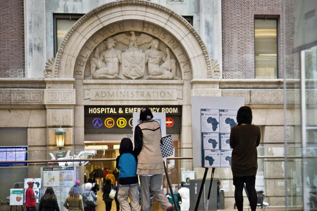 Health alerts for travelers to particular West African countries posted at the main lobby entrance of Bellevue Hospital in New York, Oct. 24, 2014. Bellevue, the country's oldest public hospital, had been preparing for an Ebola patient in earnest since August. And when Ebola did come to New York via Dr. Craig Spencer, he was transported to Bellevue by specially trained emergency workers cloaked in protective gear. (AP Photo/Bebeto Matthews)