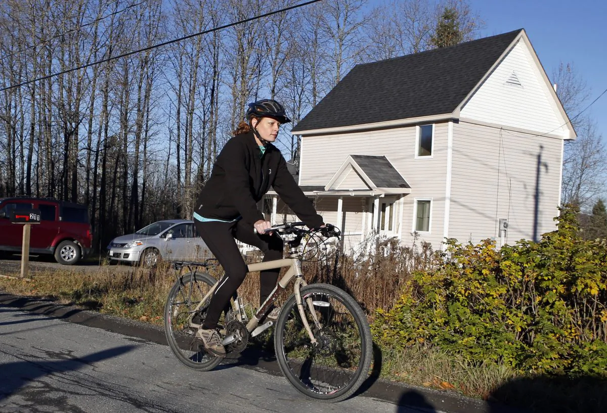Nurse Kaci Hickox leaves her home on a rural road in Fort Kent, Maine, to take a bike ride with her boyfriend Ted Wilbur, on Oct. 30. State officials are going to court to keep Hickox in quarantine for the remainder of the 21-day incubation period for Ebola that ends on Nov. 10. (AP Photo/Robert F. Bukaty)