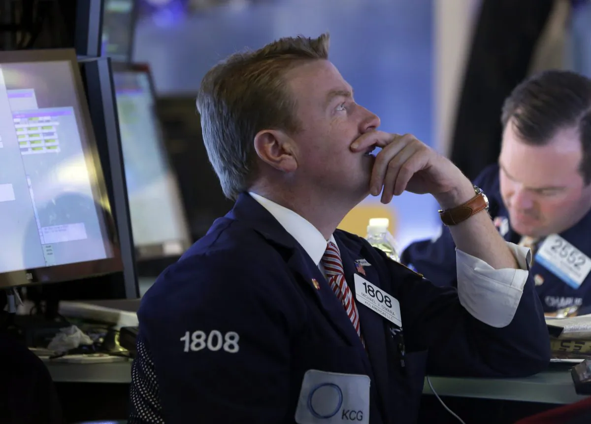 Specialist Michael O'Mara (L) works on the floor of the New York Stock Exchange Wednesday, Oct. 15, 2014. (AP Photo/Richard Drew)