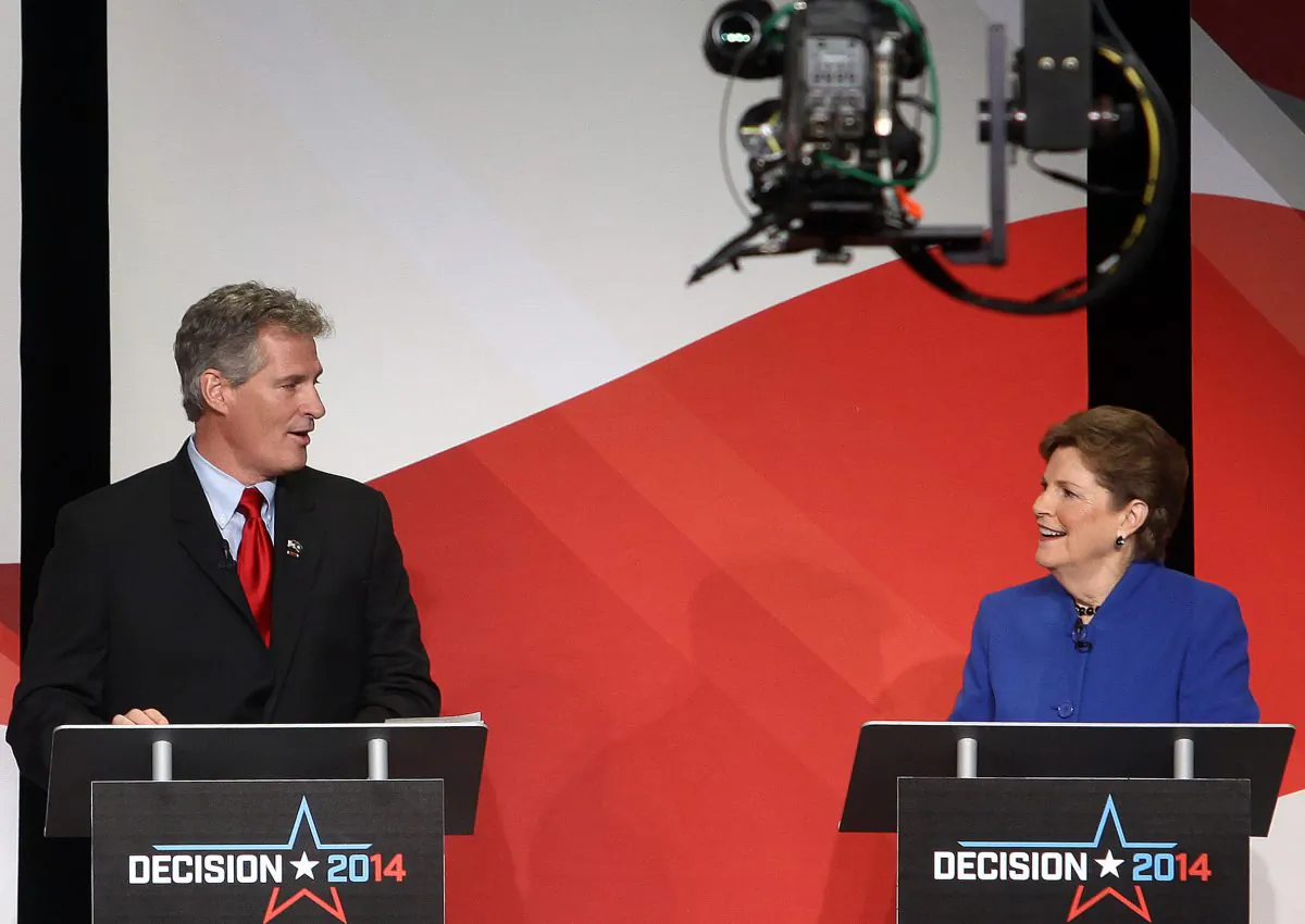 US Sen. Jeanne Shaheen (R) and her Republican challenger Scott Brown talk during a live televised debate hosted by New England Cable News, the Concord Monitor, and the University of New Hampshire at the Capitol Center for the Arts in Concord, N.H., on Oct. 21, 2014. New Hampshire’s Senate race, which includes media markets in Maine and Massachusetts - is seeing, on average, a three-fold increase in spending on political advertising, but prime ad time is far more saturated. (AP Photo/Concord Monitor, Geoff Forester)