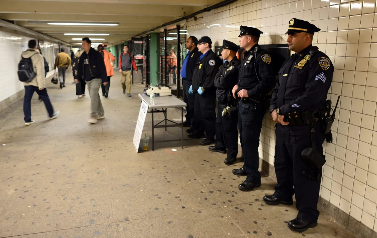 New York Police Department (NYPD) officers man a checkpoint at the entrance of a subway station in Queens, New York, on Oct. 24, 2014, one day after a man charged at four New York police officers with a metal hatchet, hitting two of them. (Jewel Samad/AFP/Getty Images)