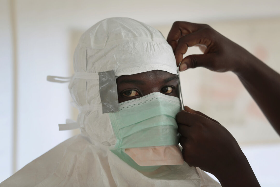 An MSF nurse is prepared with Personal Protection Equipment before entering a high risk zone of MSF's Ebola isolation and treatment center in Monrovia, Liberia, on Sept. 29, 2014. Six months into the worlds worst-ever Ebola outbreak, and the first to happen in an unprepared West Africa, the gap between what has been sent by other countries and private groups and what is desperately needed is huge. Even as countries try to marshal more resources to close the gap, those needs threaten to become much greater, and possibly even insurmountable. (AP Photo/Jerome Dela)