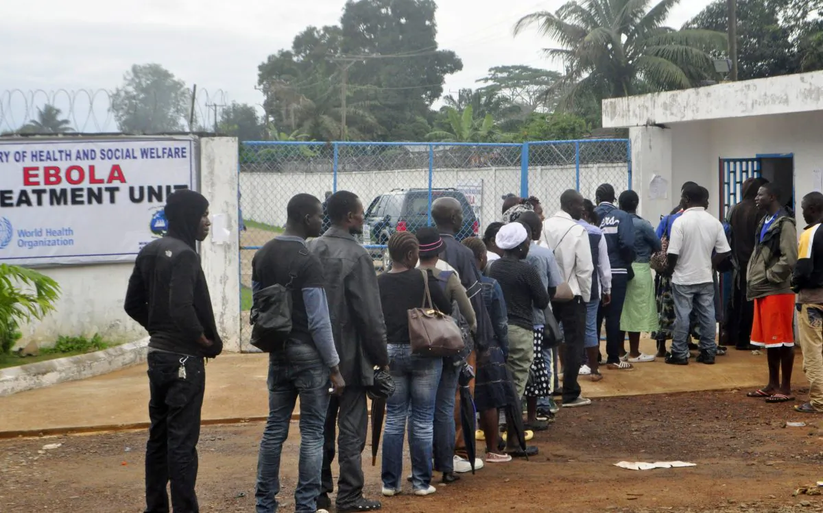 Liberian health workers queue to enter one of the largest Ebola treatment units at the Island Clinic Monrovia ,Liberia. Monday, Oct. 13, 2014. Some nurses in Liberia defied calls for a strike on Monday and turned up for work at hospitals amid the worst Ebola outbreak in history. In view of the danger of their work, members of the National Health Workers Association are demanding higher monthly hazard pay. The association has more than 10,000 members, though the health ministry says only about 1,000 of those are employed at sites receiving Ebola patients. (AP Photo/ Abbas Dulleh)