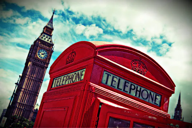 A traditional red telephone box sits beside Big Ben and The Houses of Parliament in Parliament Square in London on August 4, 2012. (Will Oliver/AFP/Getty Images; effects added by Epoch Times)