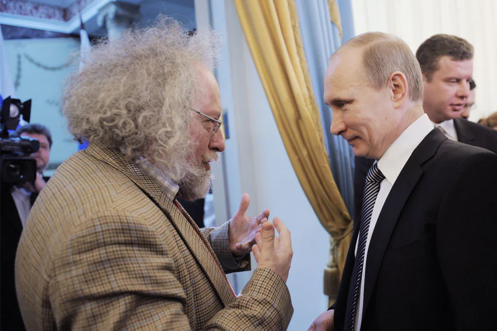 Russia's Prime Minister Vladimir Putin (R) speaks with Ekho Moskvy radio's editor-in-chief Alexei Venediktov (L) during an awarding ceremony in Moscow, on Jan. 13, 2012. (Yana Lapikova/Ria-Novosti/AFP/Getty Images)