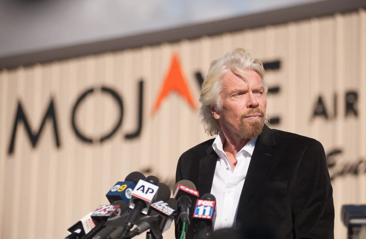 Virgin founder Sir Richard Branson speaks at a press conference at the Mojave Air and Space Port in Mojave, California on Nov. 1, 2014. British tycoon Richard Branson insisted Saturday his dream of commercial space travel remained alive but warned his company would not 'press on blindly' without knowing what caused the spacecraft crash that killed one pilot and seriously injured another. Speaking to reporters after arriving in the California facility which had been the hub of Virgin Galactic's ambitious space program, Branson said safety remained his paramount concern. 'We owe it to our test pilots to find out exactly what went wrong, and once we've found out what went wrong, if we can overcome it, we'll make absolutely certain that the dream lives on,' Branson told reporters. His comments at the Mojave Air and Space Port came as a team of federal investigators began probing the causes of Friday's accident, which dealt a devastating setback to the cause of commercial space tourism. (Josh Edelson/AFP/Getty Images)