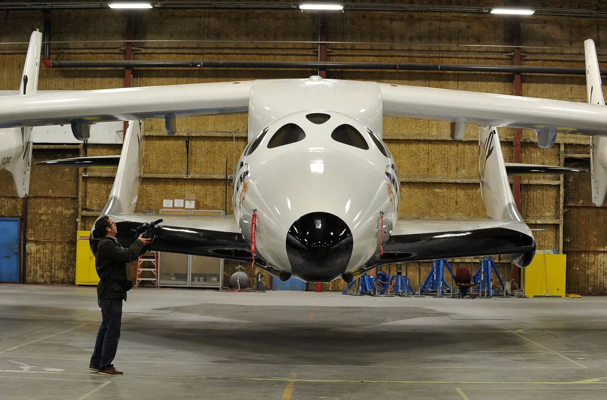 A journalist photographs Virgin Galactic's SpaceShipTwo, on Dec. 7, 2009, at the Mojave Air and Space Port in Mojave, California. (Robyn Beck/AFP/Getty Images)