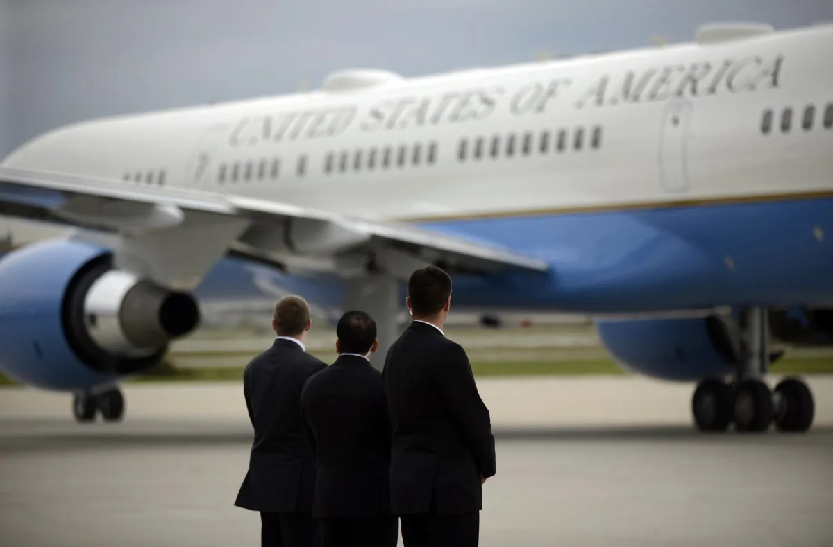 Members of the Secret Service watch as Air Force One taxies on the runway before leaving the Gary/Chicago International Airport in Gary, Ind., on Oct. 2, 2014. In the space of just a few months, the reputations and approval ratings of the Centers for Disease Control and Prevention, Secret Service, as well as the Veterans Administration, have been seen a decline. (AP Photo/Paul Beaty)