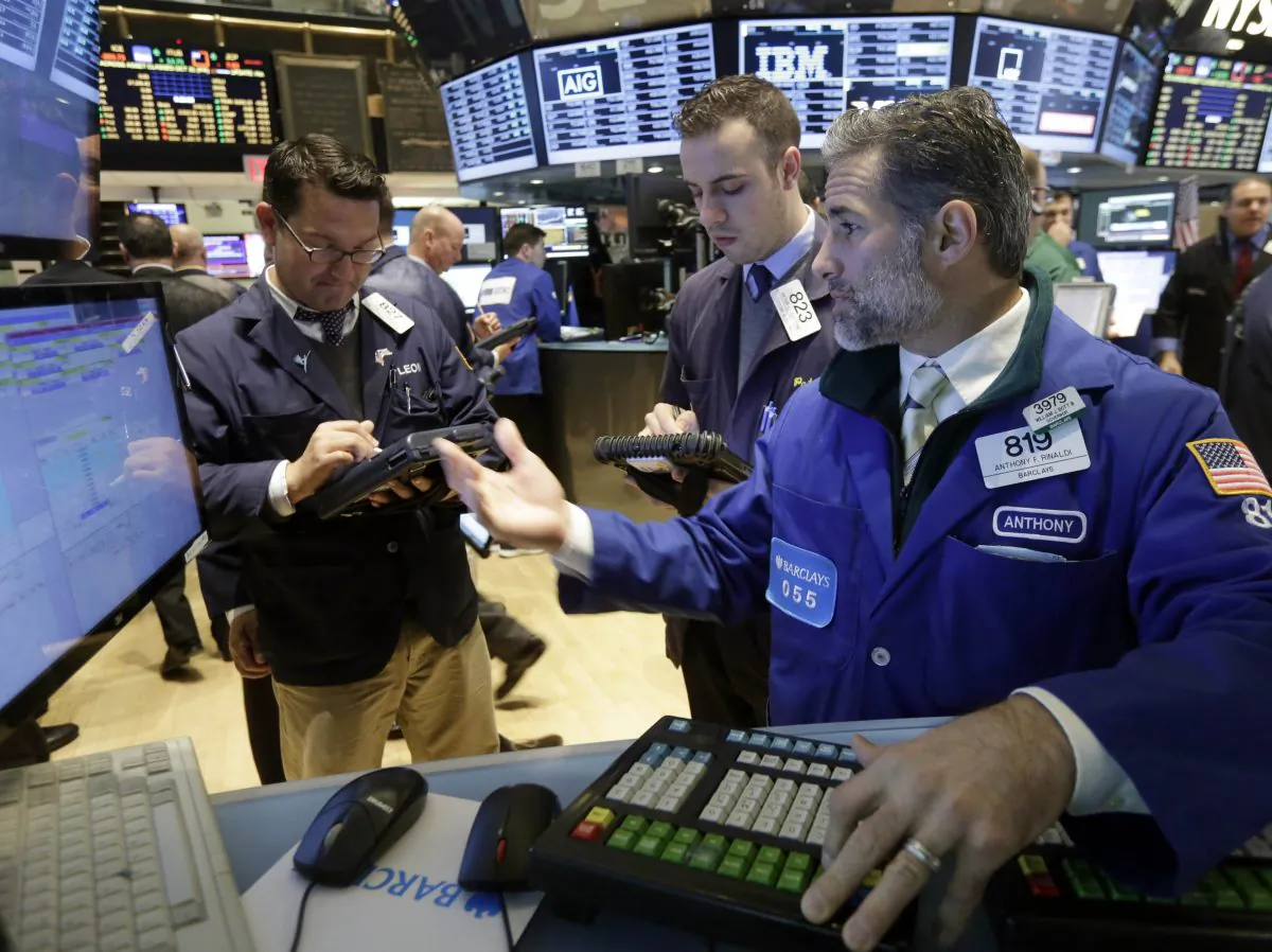 Specialist Anthony Rinaldi (R) works at his post on the floor of the New York Stock Exchange, Friday, Oct. 31, 2014. (AP Photo/Richard Drew)