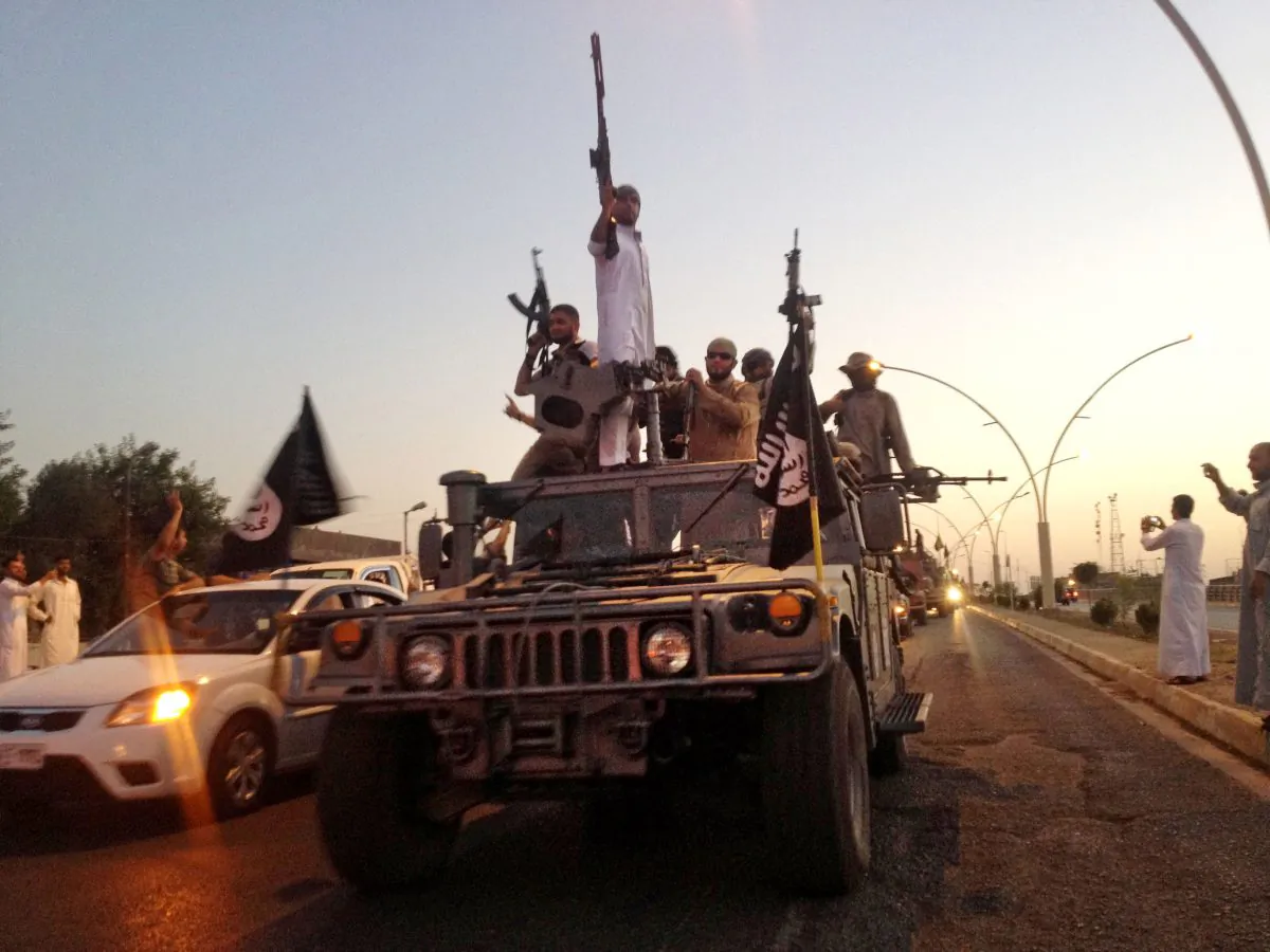 Militants from the Islamic State parade in a commandeered Iraqi security forces armored vehicle on a main street in Mosul, Iraq, on June 23, 2014. The Islamic state group has accelerated killings of former policemen and army officers, apparently fearing they might join a potential internal Sunni uprising against its rule. Such killings, including the deadly attack on police Col. Mohammed Hassan and his son in mid October, have accelerated in recent days, as the extremists' opponents - Kurdish fighters and Shiite militias, backed by US-led airstrikes - have made some gains, taking back several towns that the militants had overrun. (AP Photo)