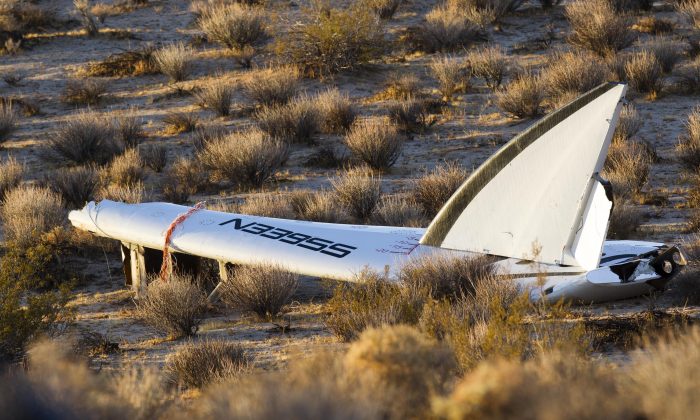Wreckage lies near the site where a Virgin Galactic space tourism rocket, SpaceShipTwo, exploded and crashed in Mojave, Calif. Saturday, Nov 1, 2014. The explosion killed a pilot aboard and seriously injured another while scattering wreckage in Southern California's Mojave Desert, witnesses and officials said. (AP Photo/Ringo H.W. Chiu)