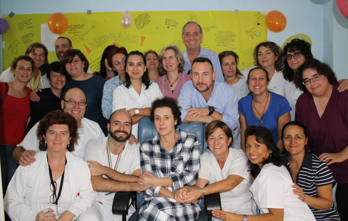 Teresa Romero (C) poses for a photo with medical workers and friends after leaving the isolation unit in the Carlos III hospital in Madrid, Spain, on Nov. 1, 2014. Hospital officials say a Spanish nursing assistant who recovered from an Ebola virus infection has left the isolation unit where she was being monitored and moved to a normal room. Teresa Romero tested positive on Oct. 6, but was declared cured of the virus 15 days later. She was the first known person to contract the disease outside of West Africa in the latest outbreak. Madrids Carlos III hospital said Saturday that Romero, 44, was now being attended by hospital staff that no longer needed to wear protective outfits. (AP Photo/Carlos III Hospital)