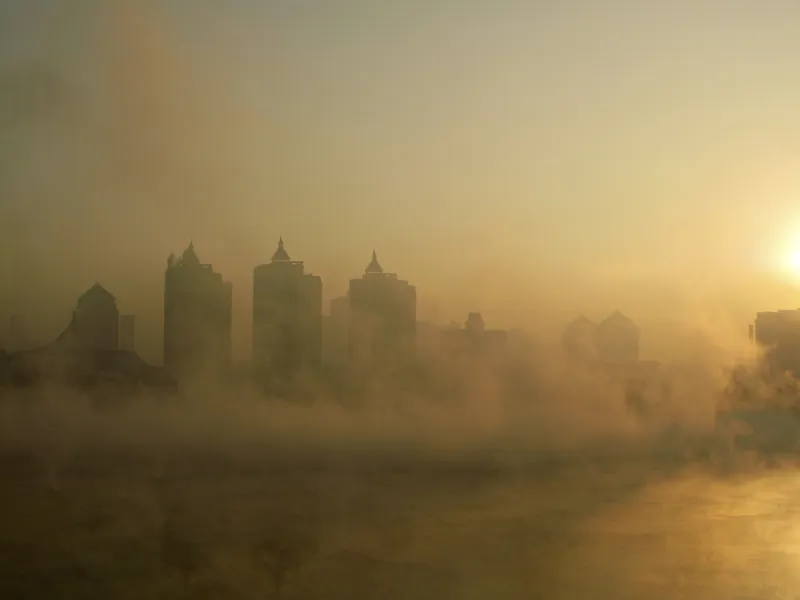 A ship sails up the Huangpu River under a hazy sky in Shanghai on Jan. 10, 2012. Forty-two loan underwriting companies have declared bankruptcy in the Chinese financial hub. (Peter Parks/AFP/Getty Images)